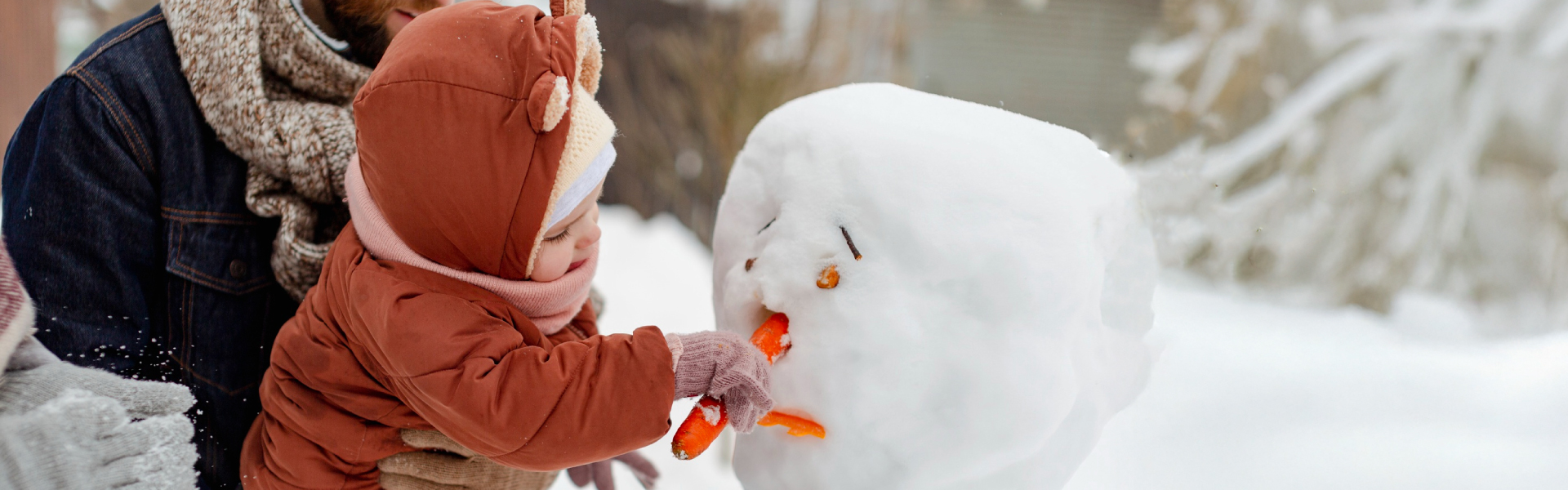 toddler building snowman